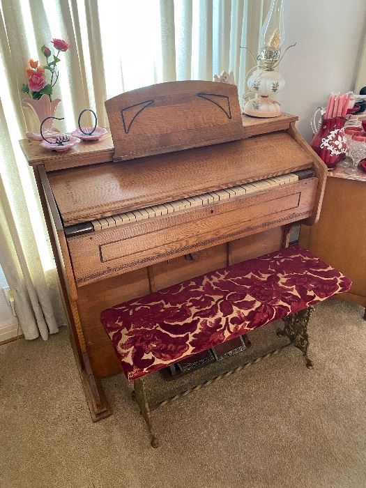 Antique pump organ with a tapestry bench