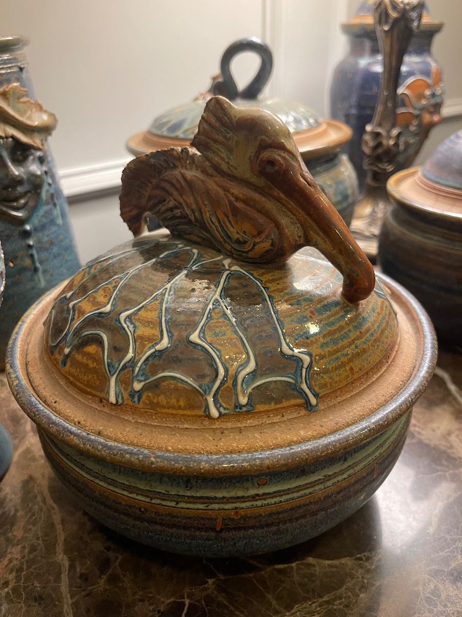 Art pottery lidded jar with a sculpted bird handle