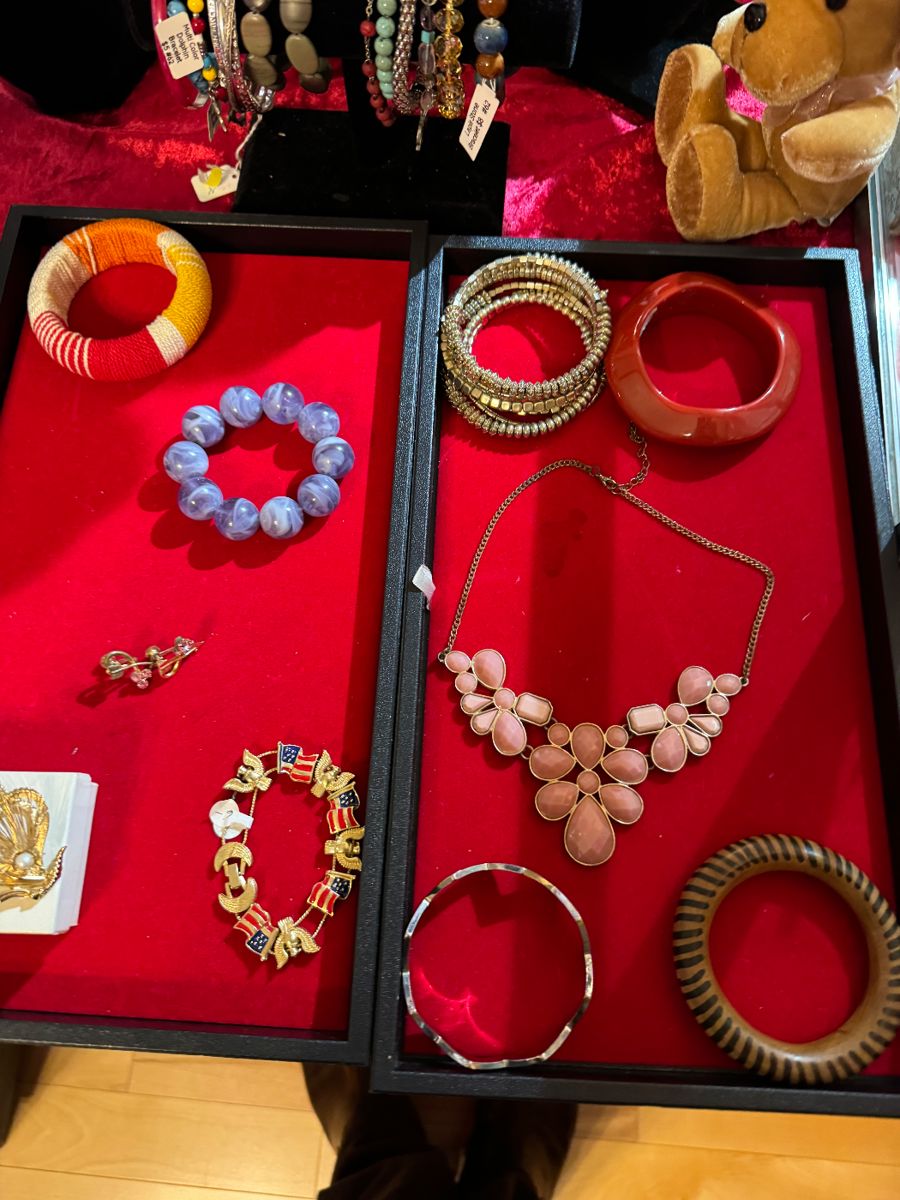 Bangles and necklaces in red jewelry trays