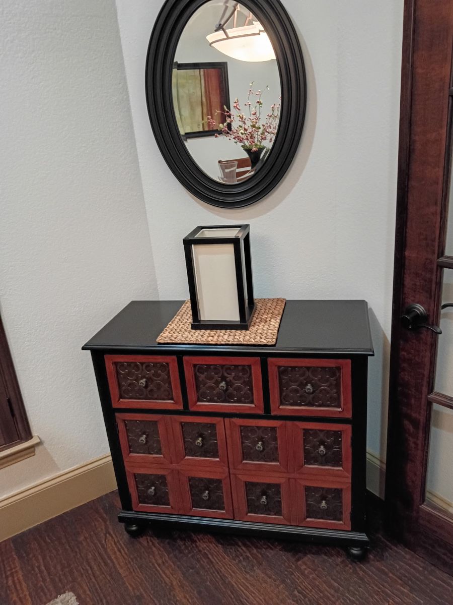 Black and red multi drawer accent chest with round mirror