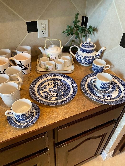 Blue Willow teapots and cups on a counter