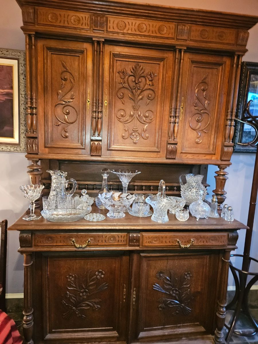 Carved antique sideboard with crystal