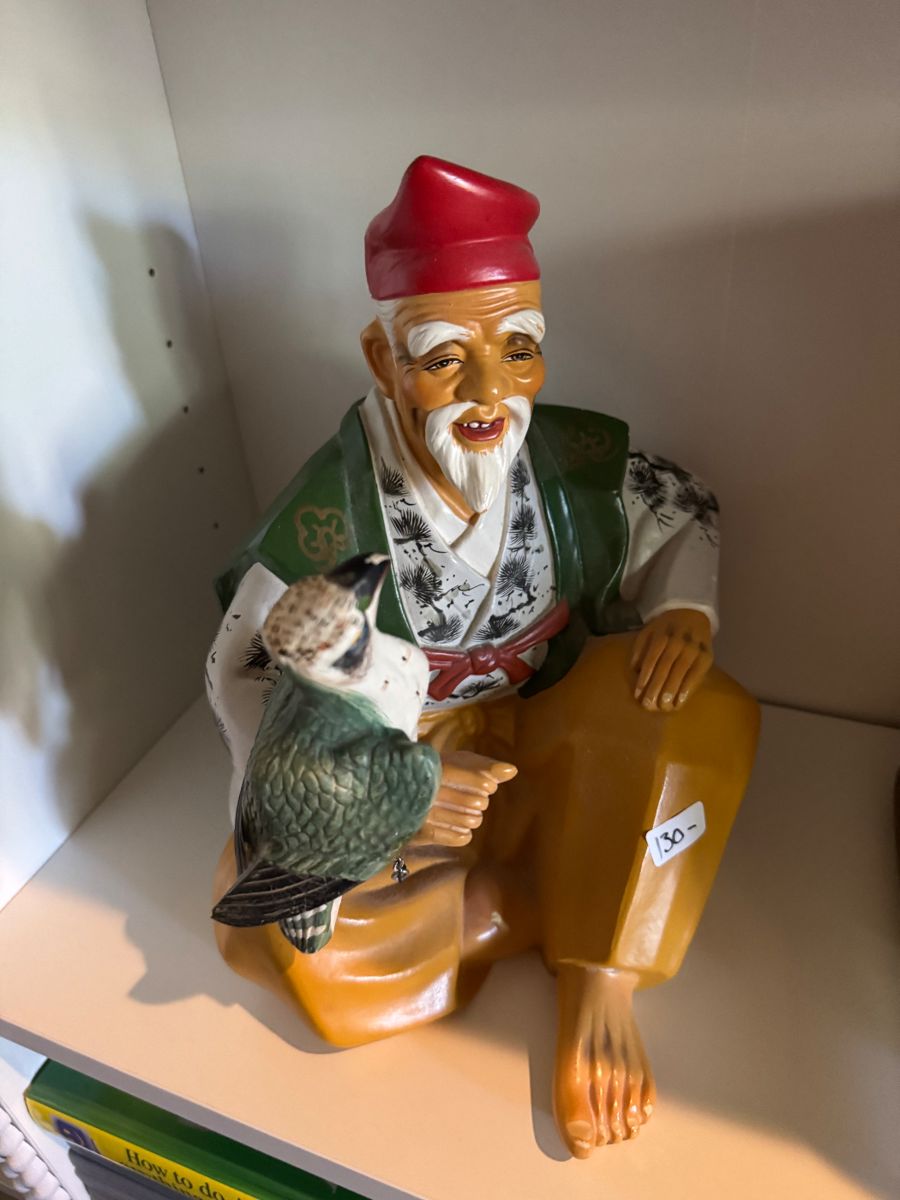 Carved fisherman figurine