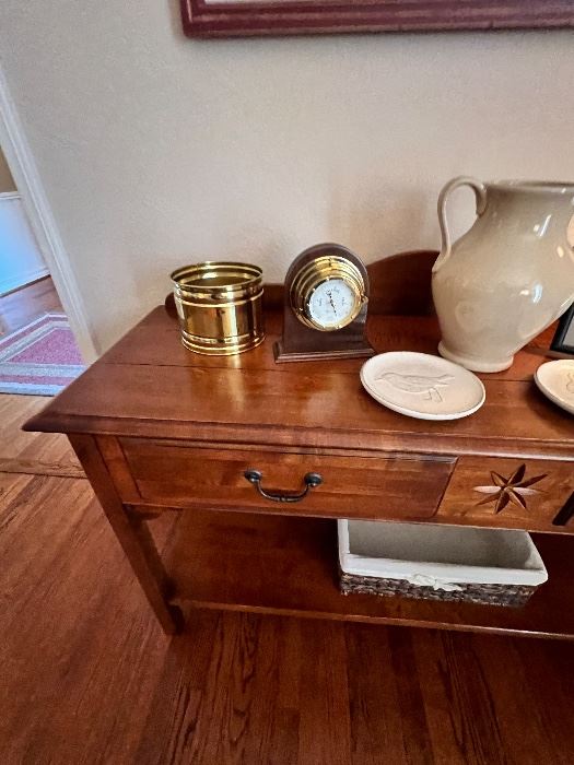 Cherry console table with brass clock and white pitcher