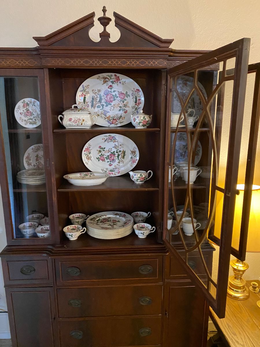 China cabinet filled with floral dinnerware