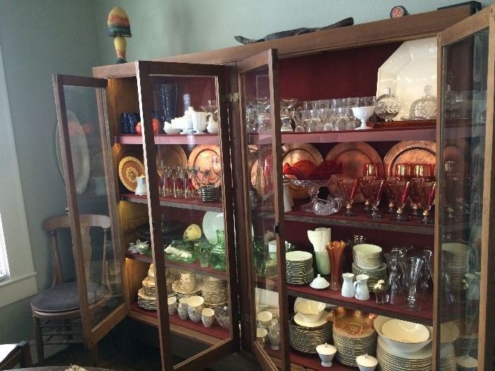 China cabinet full of vintage glassware and dishes