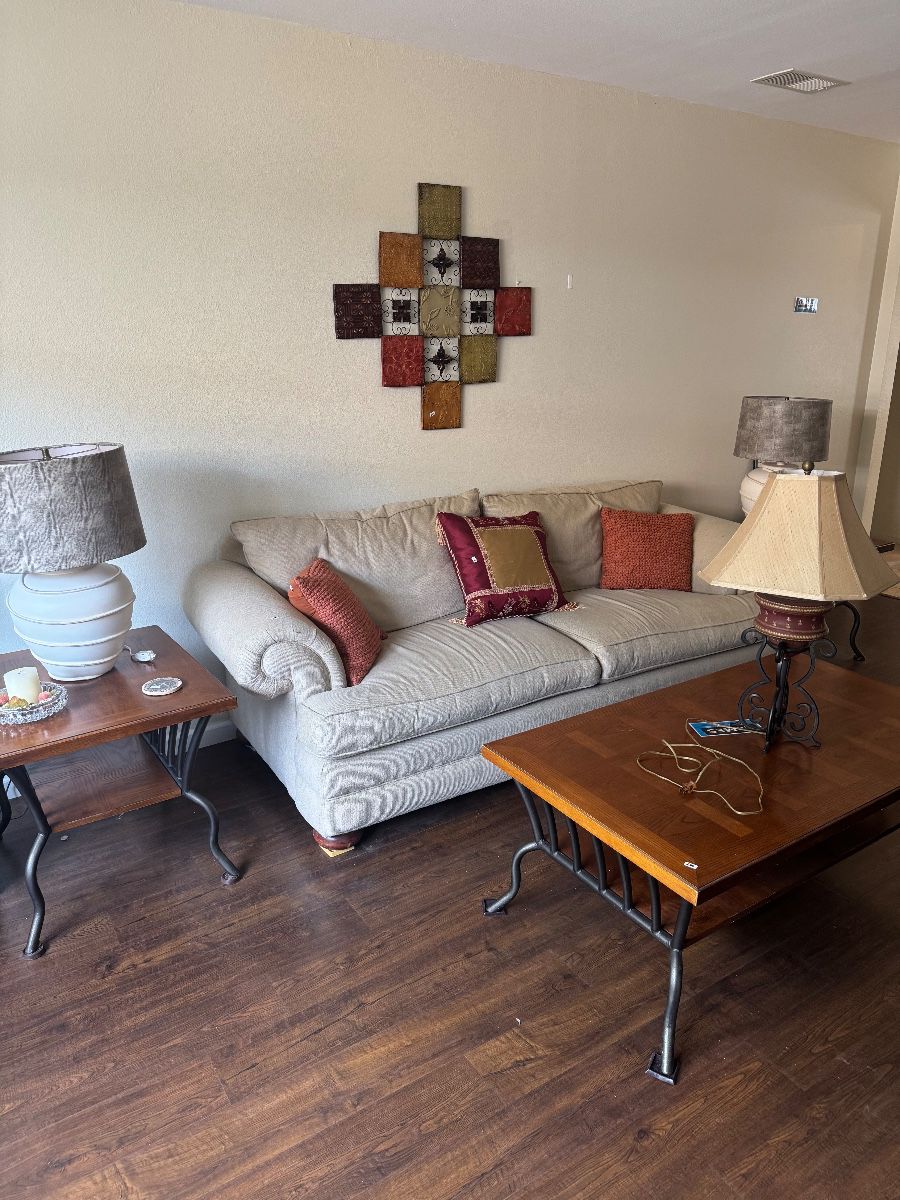 Cream rolled-arm sofa with iron-base end tables and coffee table