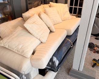 Cream upholstered sofa with throw pillows