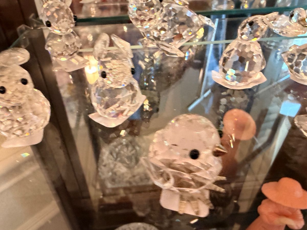 Crystal animal figurine collection in a glass curio