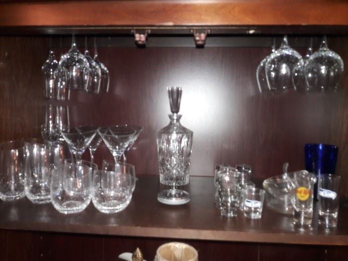 Crystal decanter and barware on lighted shelves