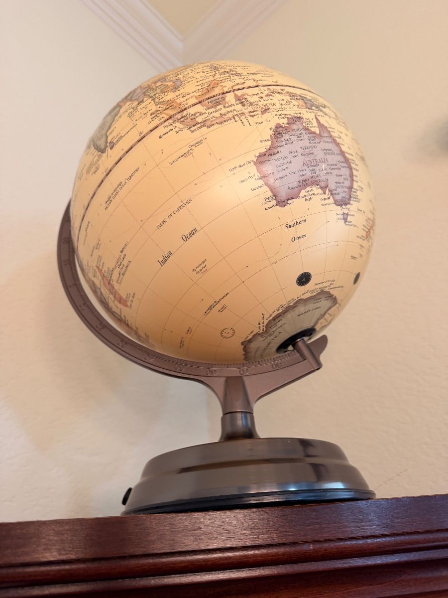 Decorative world globe on a metal stand