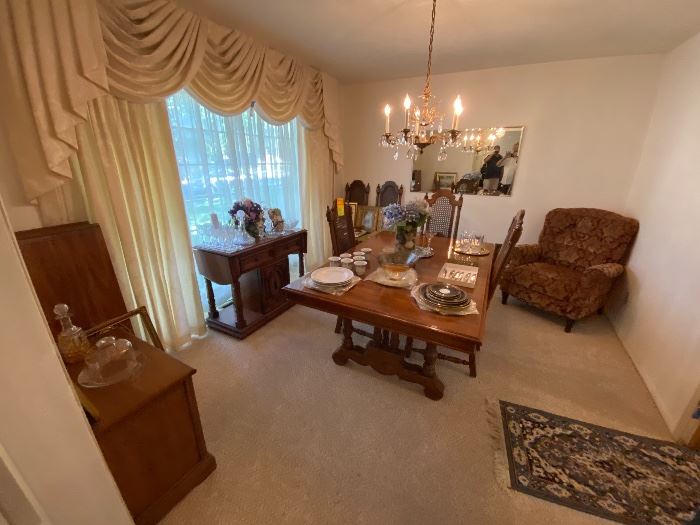 Dining room with carved table and chandelier