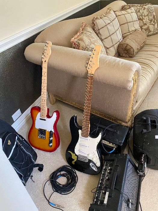 Electric guitars and amplifiers by a sofa