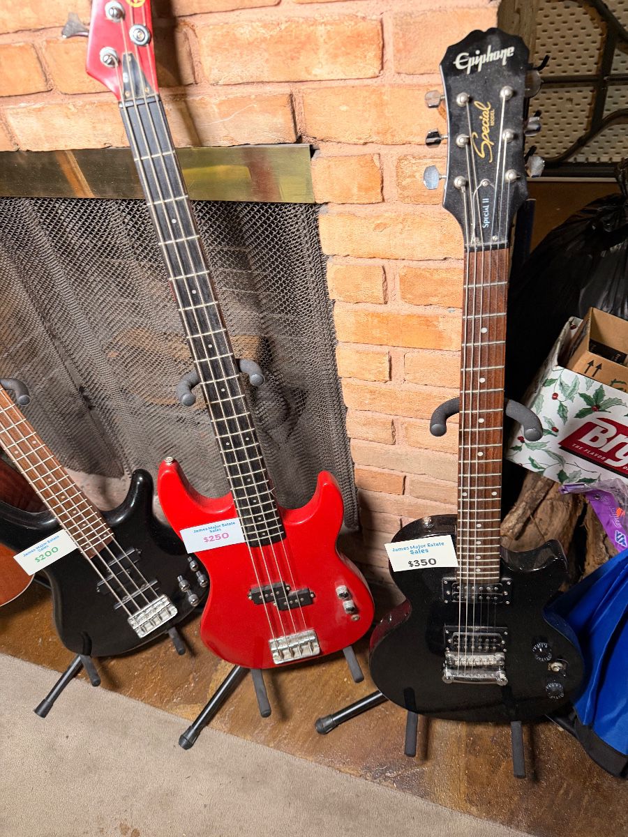 Electric guitars and bass on stands