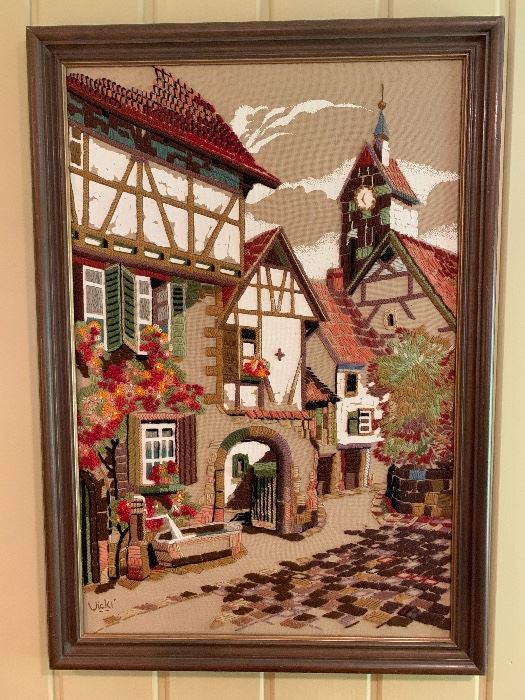 Framed needlepoint of a European village