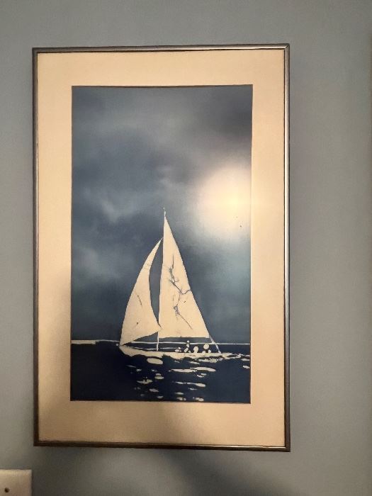 Framed sailboat print in a silver frame