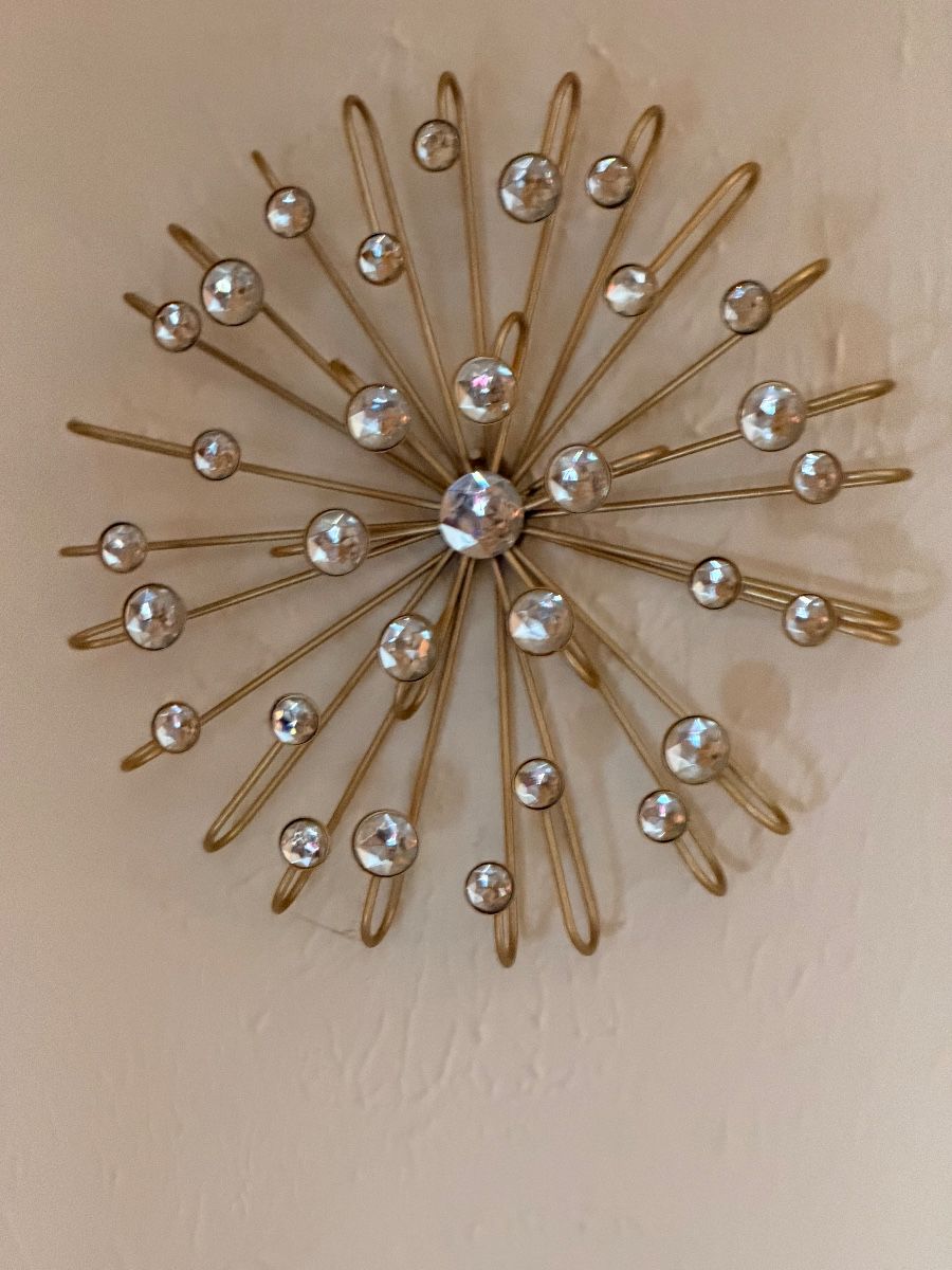 Gold starburst wall decor with crystal accents