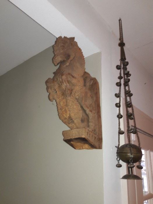 Hand-carved wooden corbel and a brass hanging scale