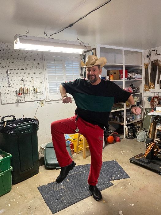 James Major of James Major Estate Sales dancing in a cowboy hat in the garage
