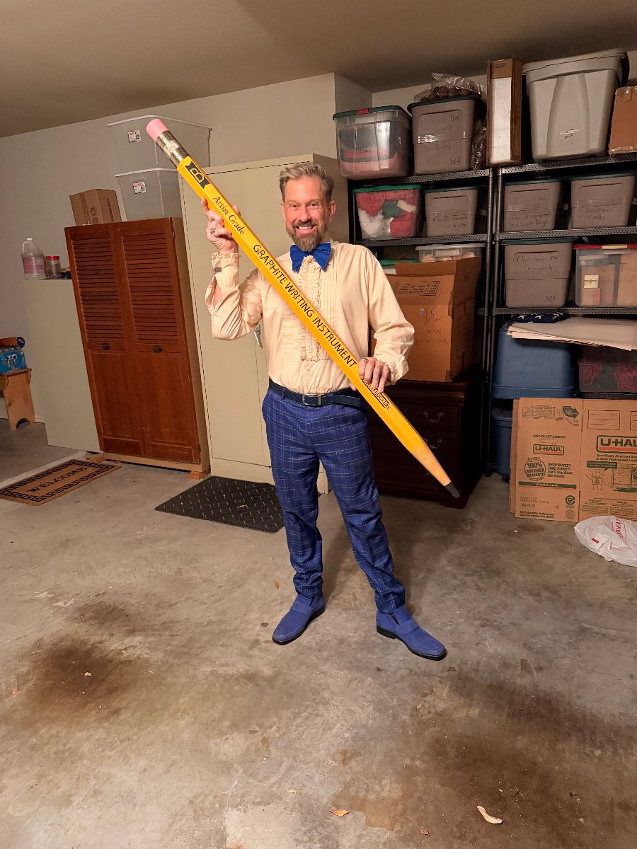 James Major of James Major Estate Sales holding a giant pencil at the Mansfield estate sale