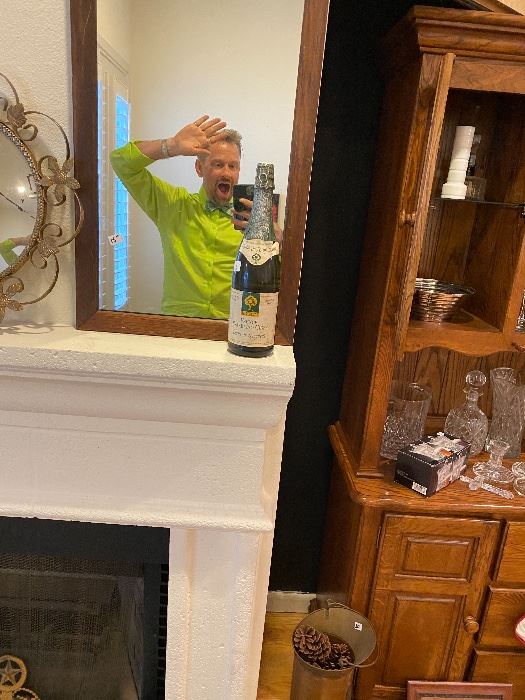 James Major of James Major Estate Sales posing in a mirror with a bottle of bubbly