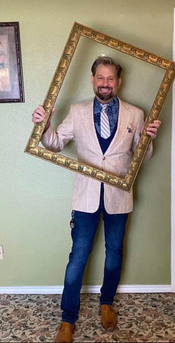 James Major of James Major Estate Sales posing in an empty gold picture frame in Hurst