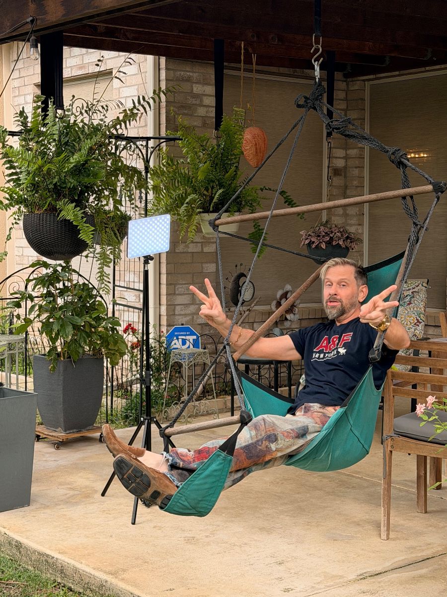 James Major of James Major Estate Sales relaxing in a hanging hammock chair at the Grand Prairie estate sale