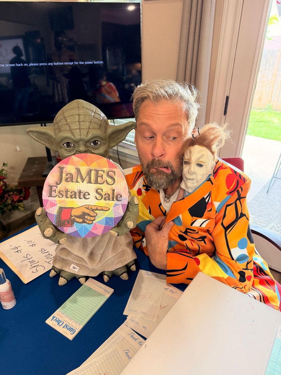 James Major of James Major Estate Sales with a Yoda figure and estate sale sign