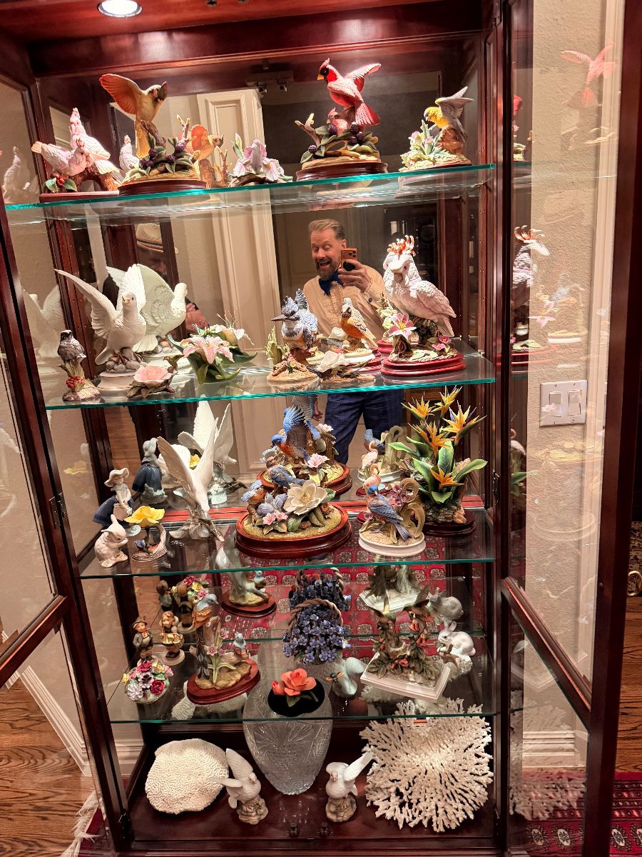 Lighted curio cabinet filled with porcelain figurines