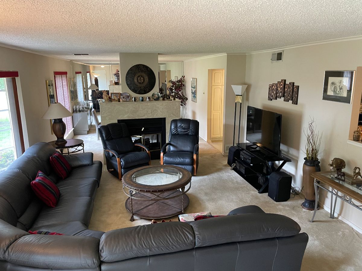 Living room with leather sofas, swivel chairs and a fireplace