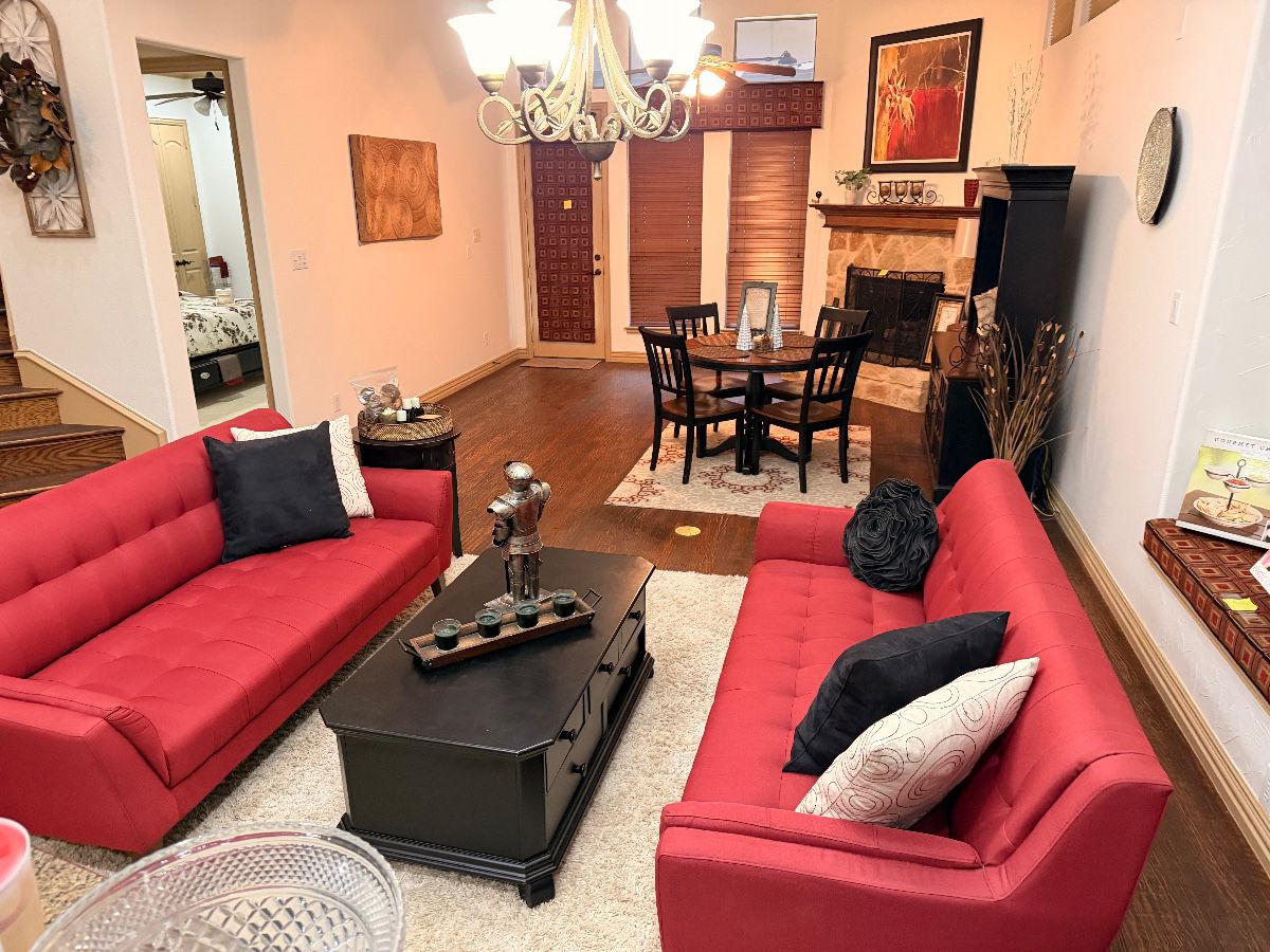 Living room with red sofas and black coffee table at an Irving estate sale