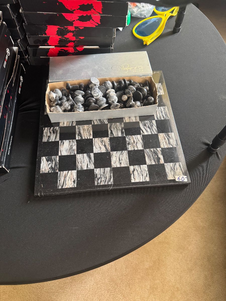 Marble-look chess board with carved stone chess pieces