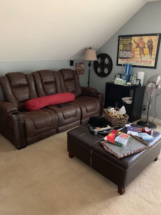 Media room with leather recliner sofa and movie posters