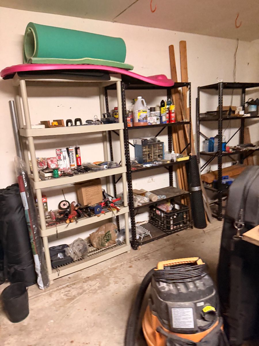 Metal garage shelving stocked with hardware and supplies