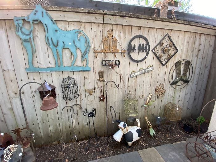 Metal horse and Western yard art on a fence at a Dallas estate sale