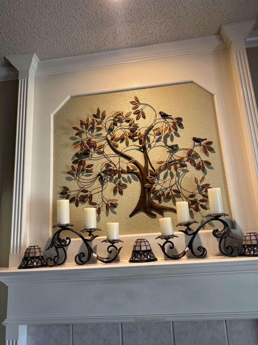 Metal tree of life wall sculpture over a mantel