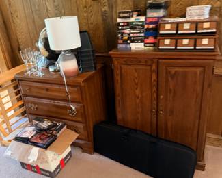 Oak nightstand and media cabinet with DVDs and decor