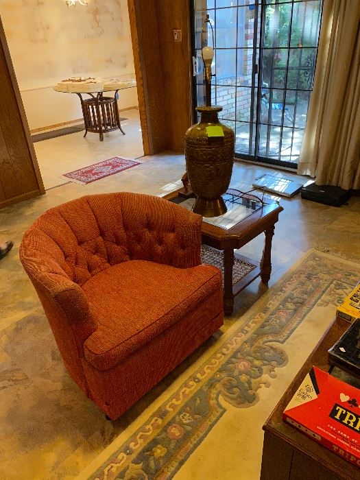 Orange tufted barrel chair in an Oak Cliff living room