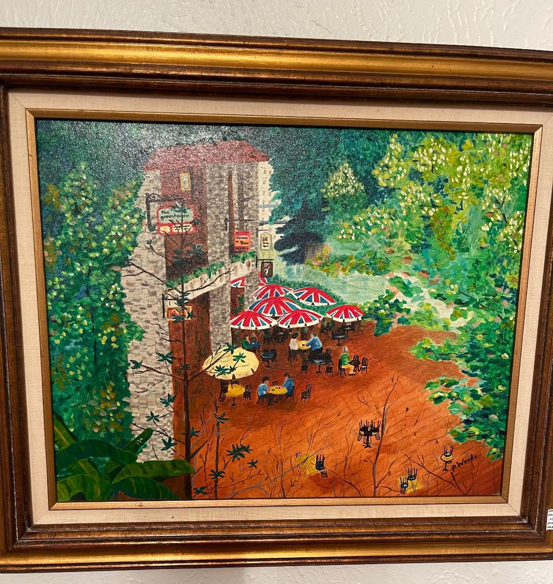 Painting of a garden cafe in a gold frame