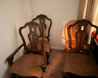 Pair of carved wood dining chairs with upholstered seats