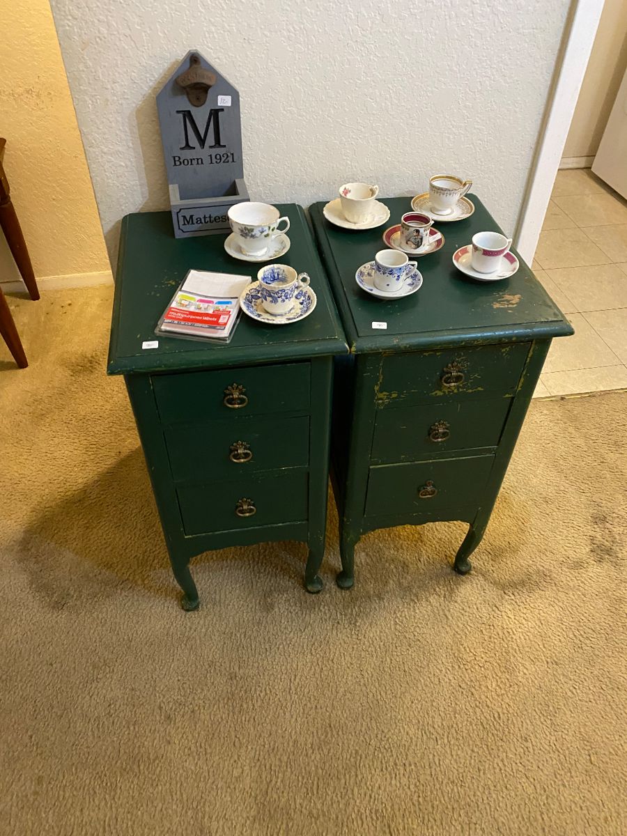 Pair of green painted nightstands with teacups