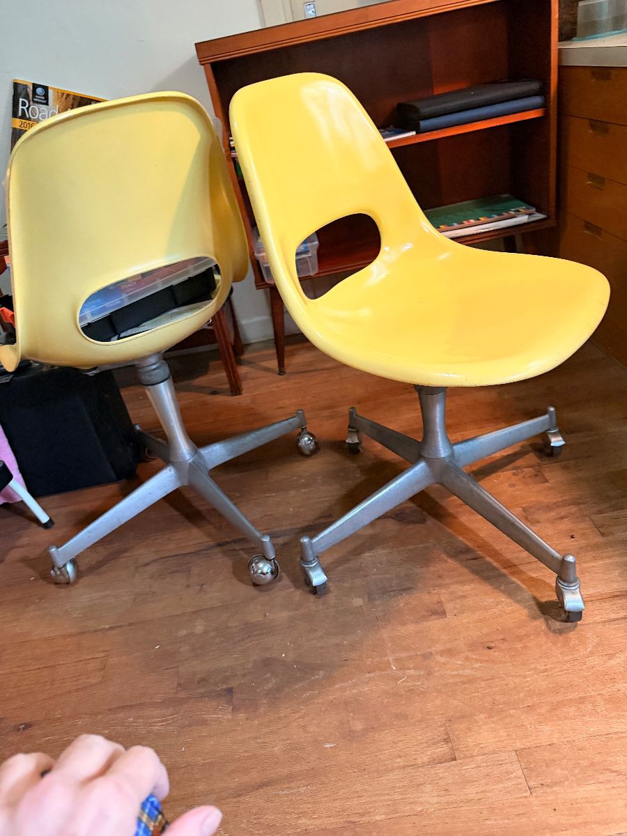 Pair of yellow fiberglass shell office chairs