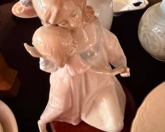 Porcelain figurine of a girl embracing a lamb