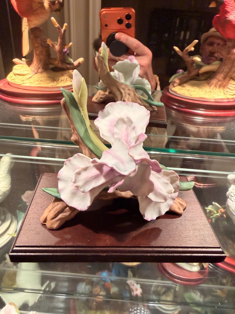 Porcelain flower sculpture on a wood base