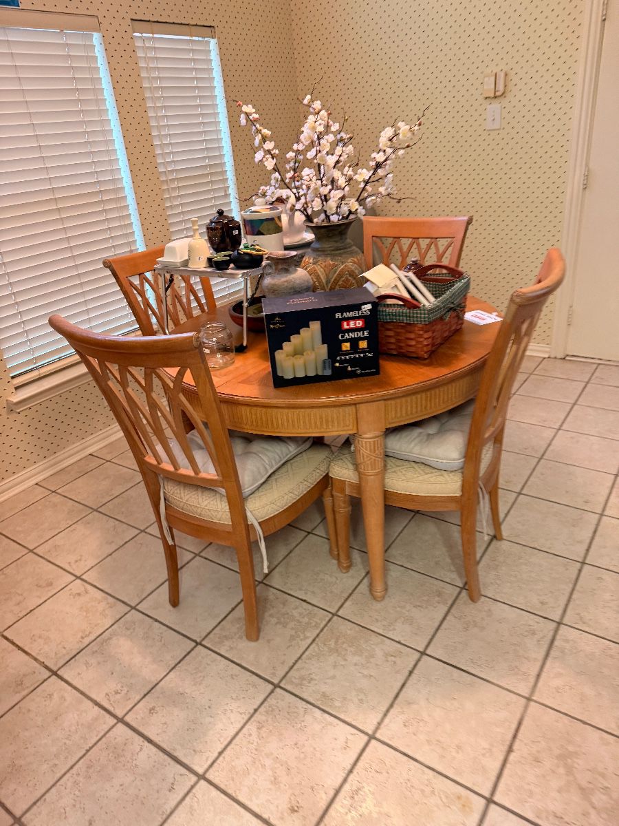 Round wood dining table with four chairs
