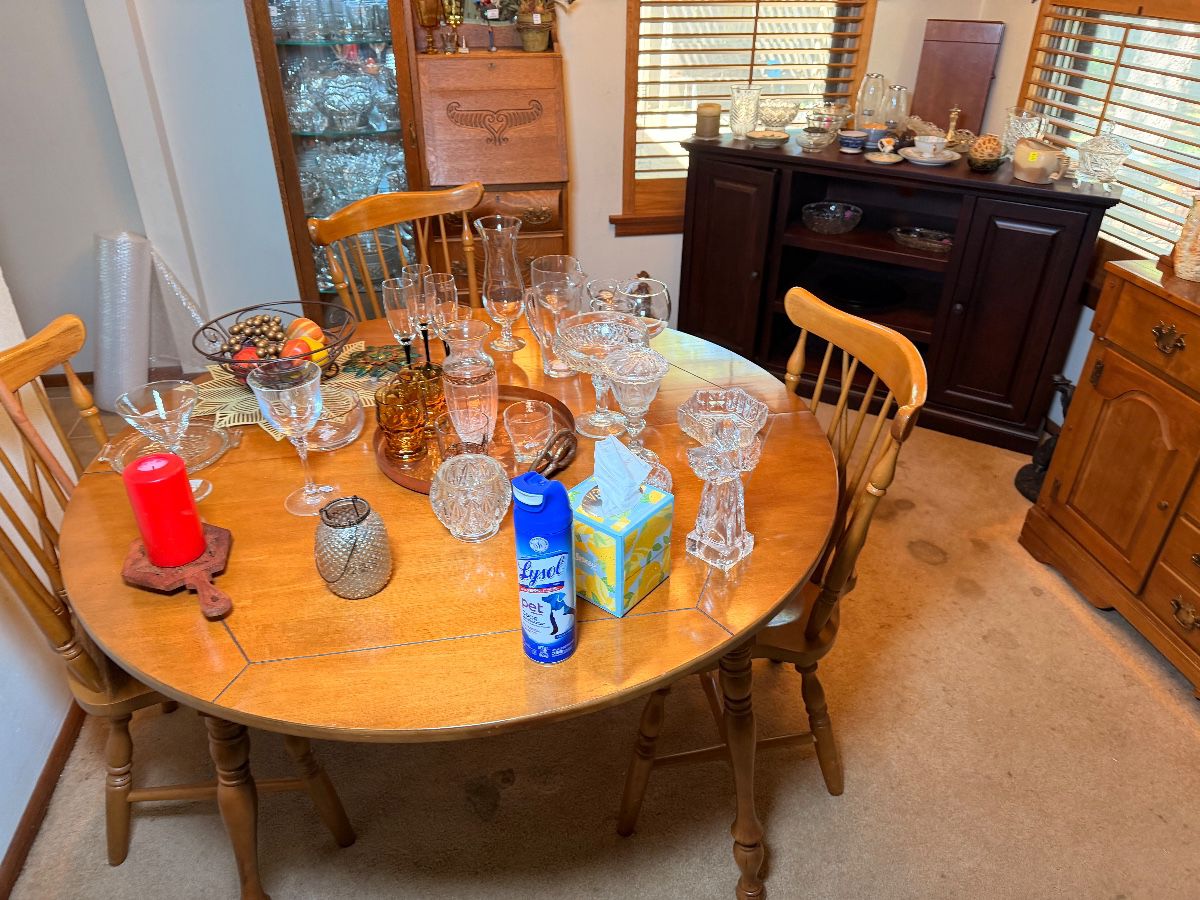 Round wooden kitchen table with four chairs