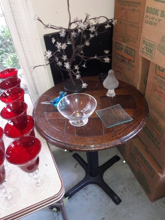 Ruby red goblets and a round wooden table