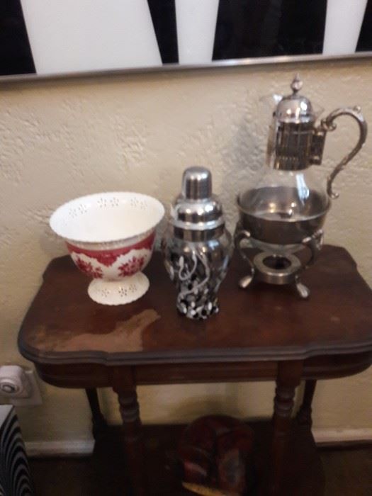 Silver cocktail shaker and coffee urn on an antique table