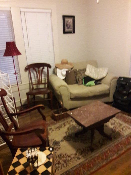Sitting room with a loveseat, rocking chair and inlaid side table