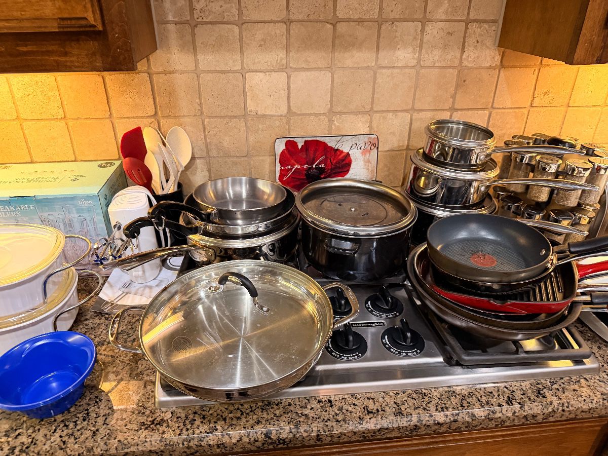 Stainless cookware set on a kitchen range